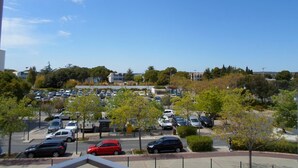 A parking lot with multiple cars, trees, and buildings in the background. - Studio near Balaruc Thermal Baths, Air-Con, Pets Allowed (Balaruc-les-Bains)