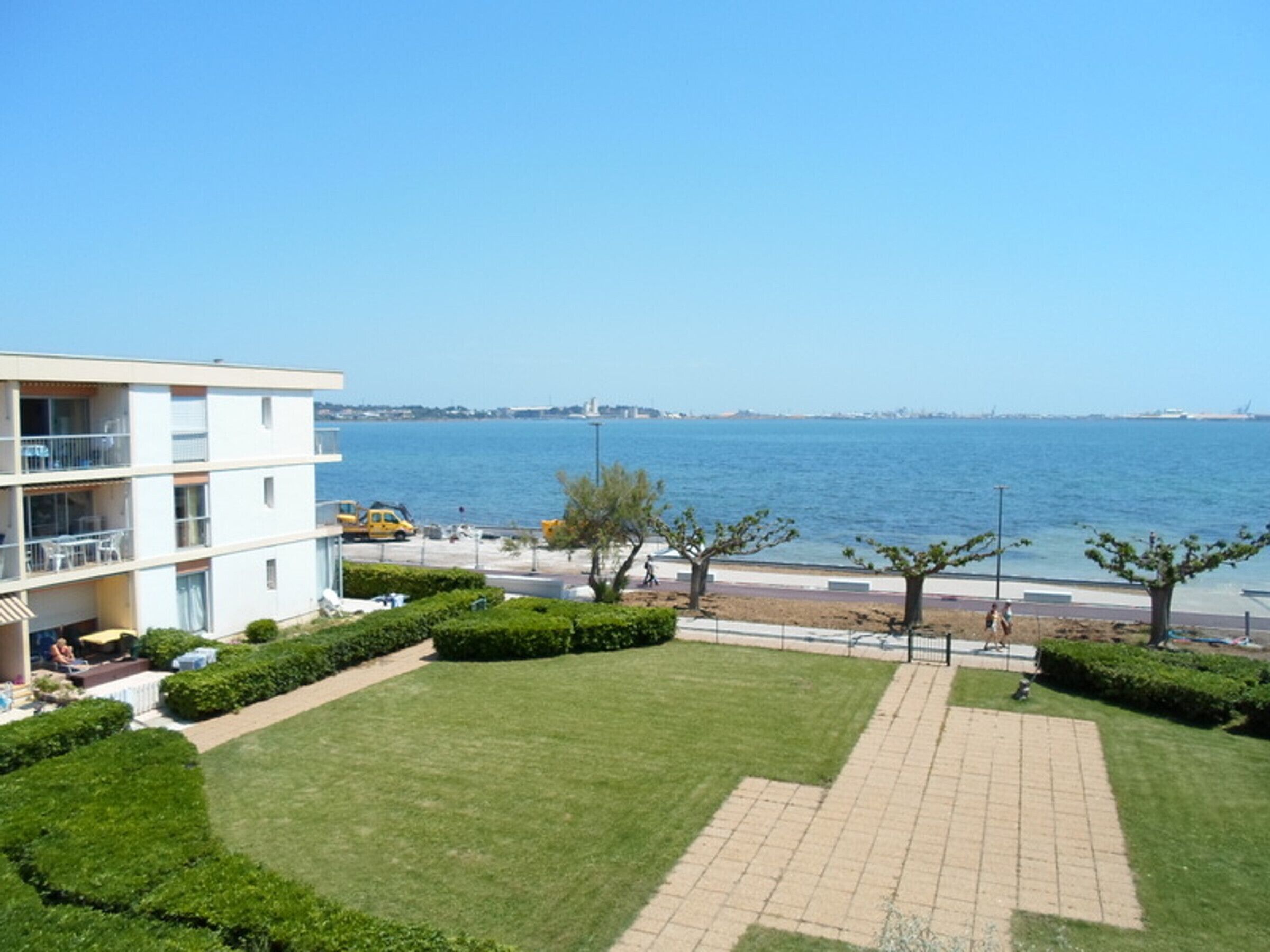 A modern apartment building with a view of the sea.