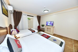 A hotel room with two beds, a TV, a fireplace, and a window with curtains. - Sapa Symphony Hotel (Sa Pa)