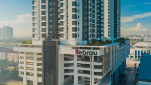 A multi-story building with a prominent 'Tebrau' sign, featuring a modern architectural design with balconies and a rooftop garden. - OYO Home 43995 Premium 3br 1tebrau (Johor Bahru)