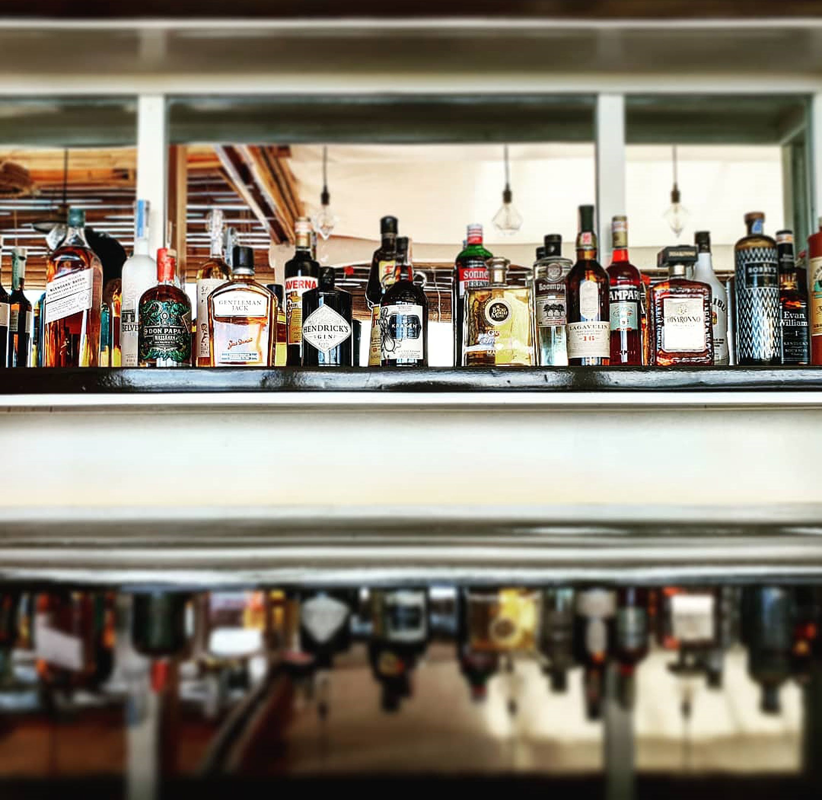 A bar with various liquor bottles displayed on shelves.