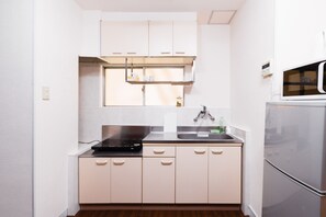 Apartment (F4-1) | Private kitchen | Fridge, microwave, stovetop, electric kettle - F-Minami (Osaka)