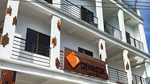 A multi-story hotel with a prominent sign reading "DENNISON HOTEL". - The Dennison Hotel (Angeles City)