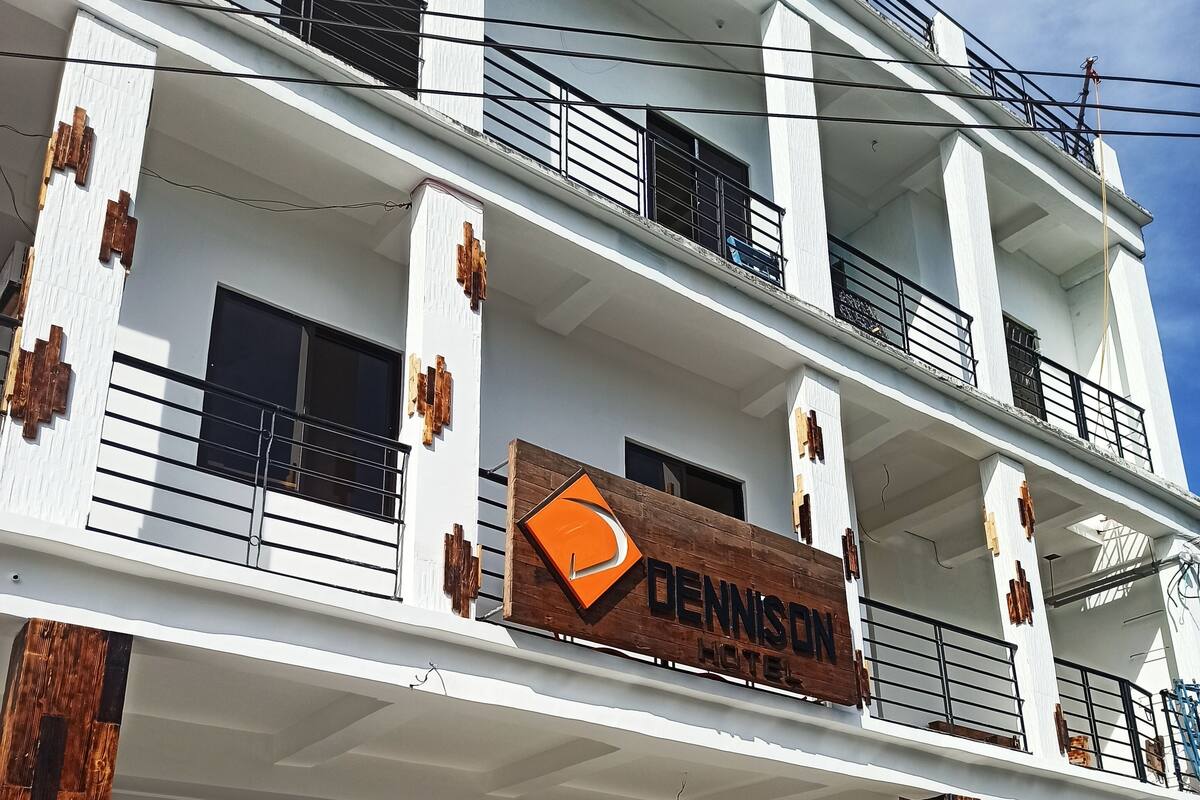 A multi-story hotel with a prominent sign reading "DENNISON HOTEL".