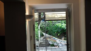 A doorway leading to a covered outdoor area with a hammock and a person lying on the ground. - Nearby Fortress and close to the center, patio and garden (Firenze)