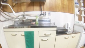 A kitchen with a stove, sink, and cabinets. - Hanazono Kita Terrace House (Osaka)