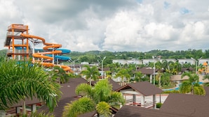 A water park with multiple water slides, surrounded by residential buildings and lush greenery. - Ban-aw Candon (Candon)
