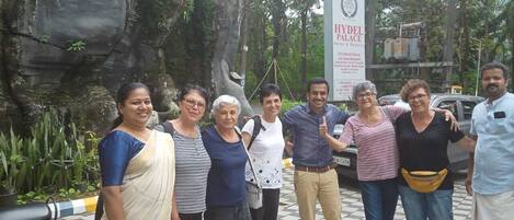 A group of people standing in front of a sign for the Hyatt Palace Hotel.
