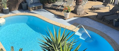 Seasonal outdoor pool, pool loungers