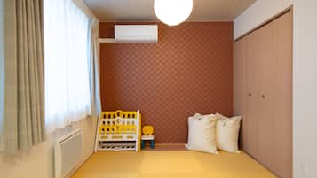 Relax in a cozy space with a single bed, a comfortable chair, and a functional layout.