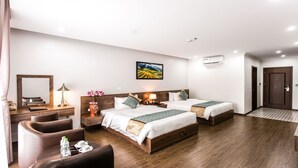 A hotel room with two beds, a desk, a chair, a mirror, and a painting on the wall. - Liberty Hotel - Events (Lao Cai)