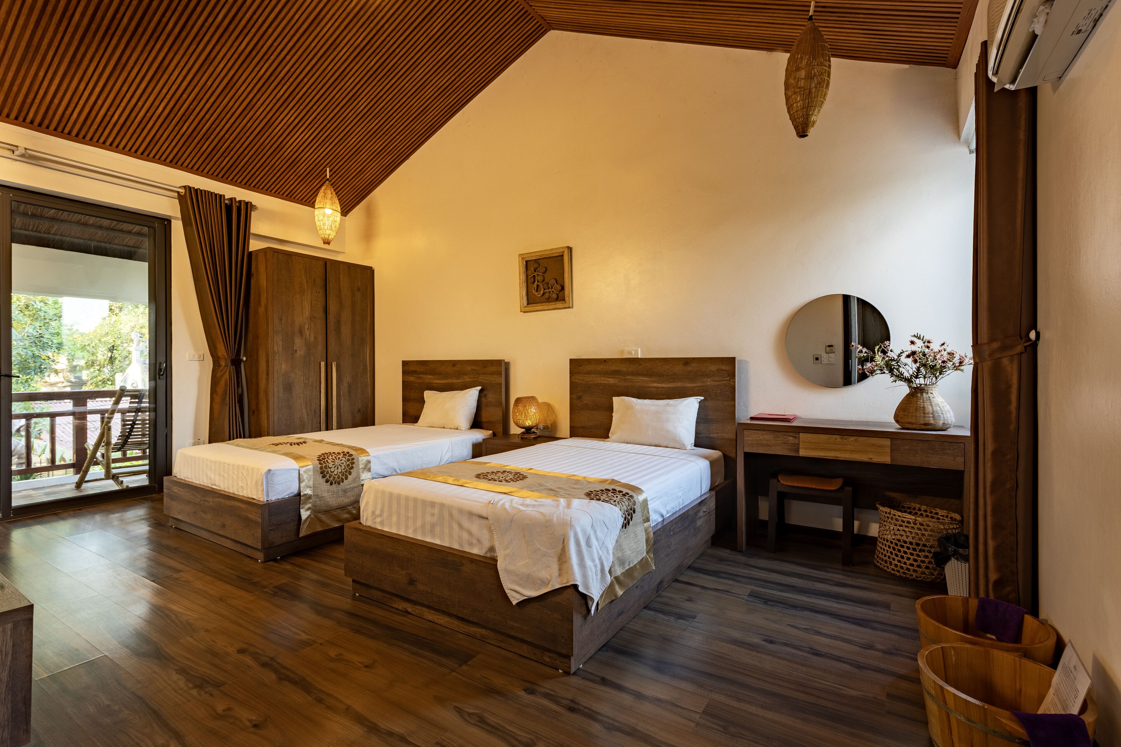 A bedroom with two beds, a desk, and a chair.