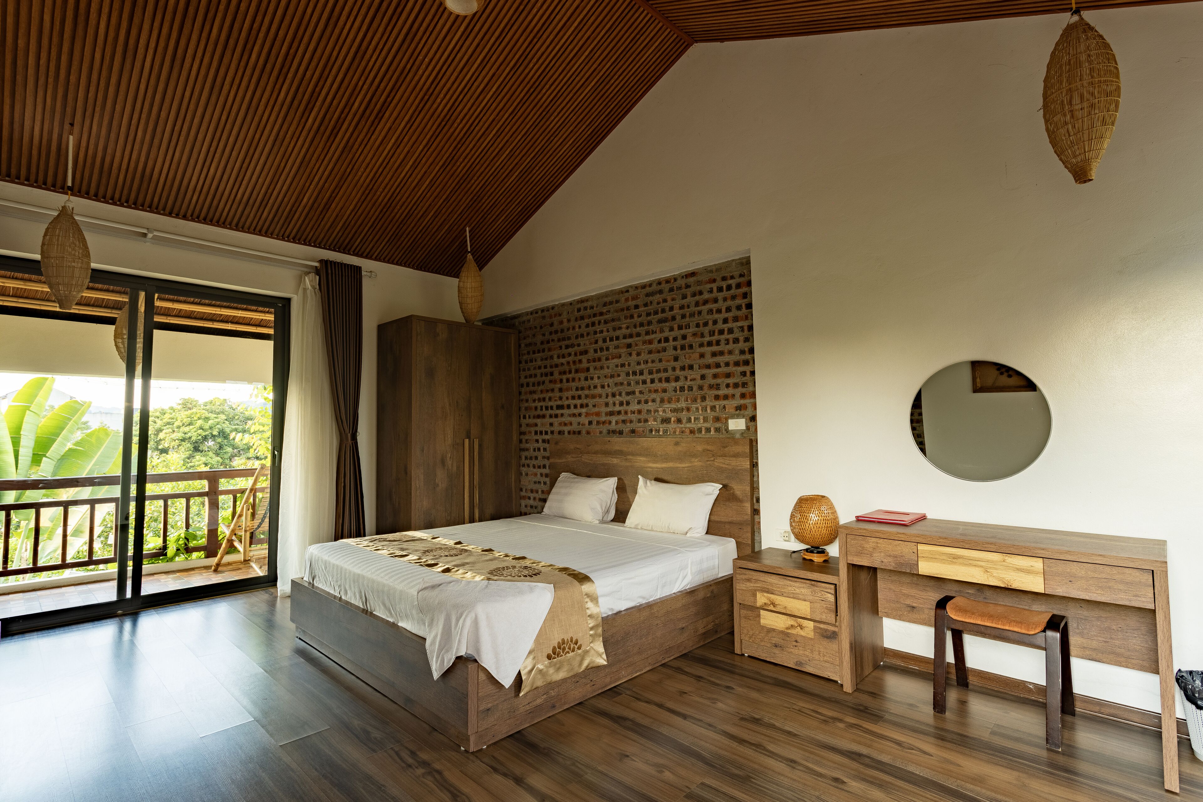 A bedroom with a bed, a desk, and a chair.