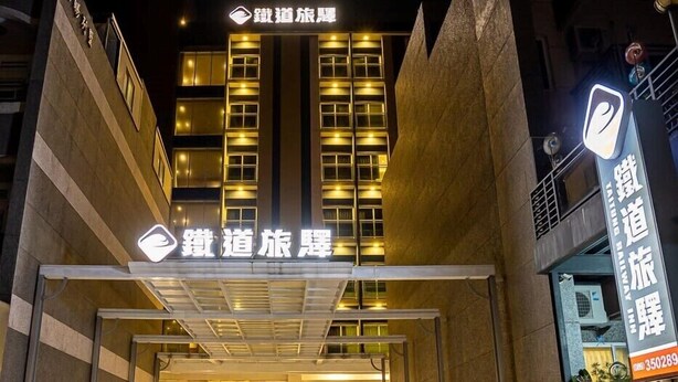 A hotel entrance with illuminated signage and a modern architectural design.