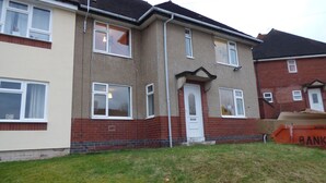 A two-story residential building with a red brick facade and white-framed windows. - Boythorpe House (Chesterfield)