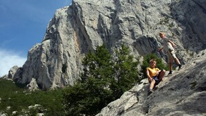 A rocky landscape with two people climbing a steep rock face. - Room in Starigrad-Paklenica with WIFI (627-7) (Starigrad)
