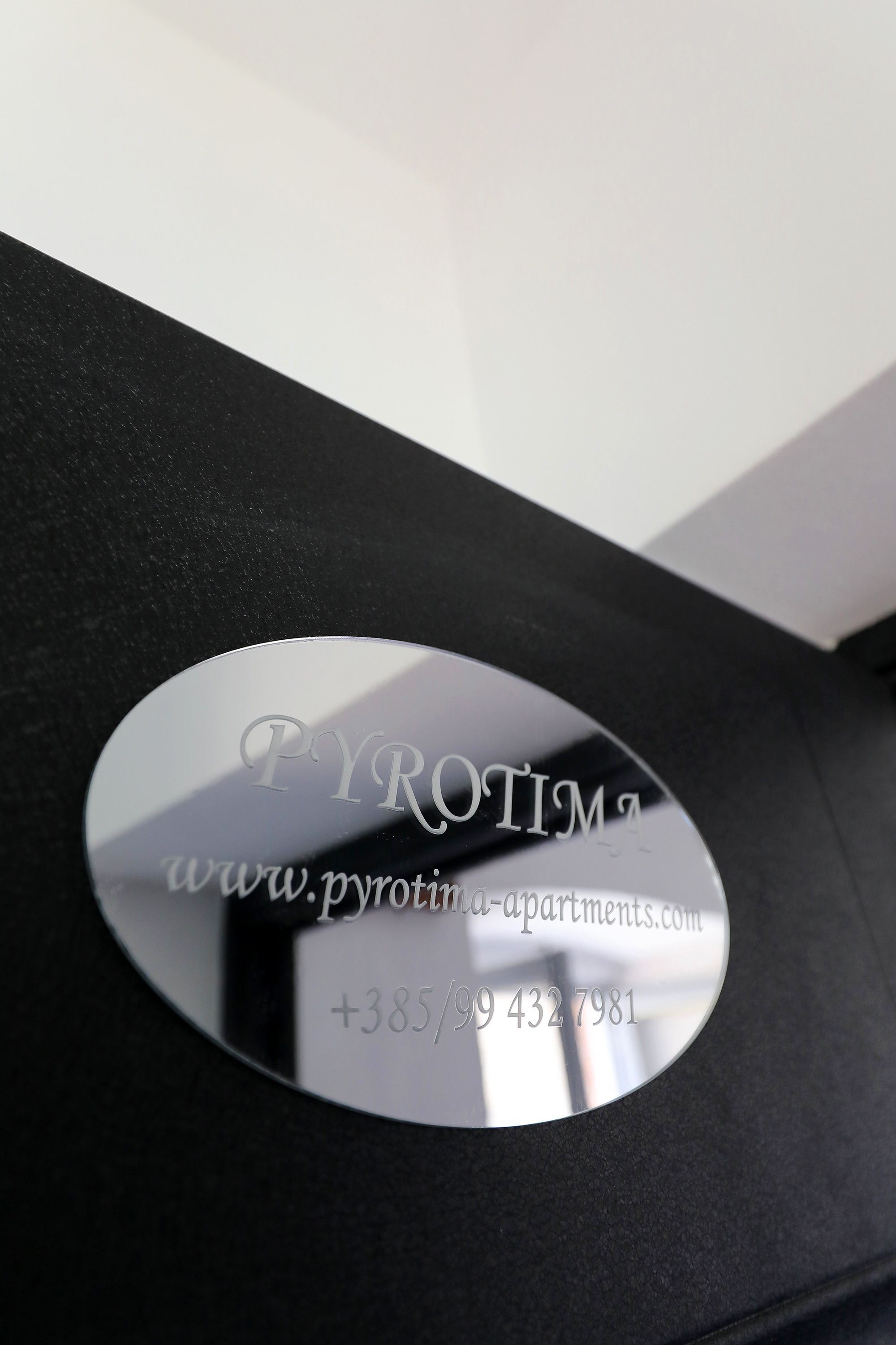 A metallic plaque with the text "PYROTIM" and a website address.