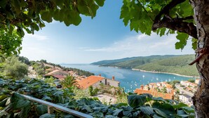 A coastal town with a view of the sea and hills. - Apartments Mandica (Rabac)