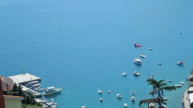 A marina with boats docked and a pier with buildings. - Apartments Elide (Rabac)