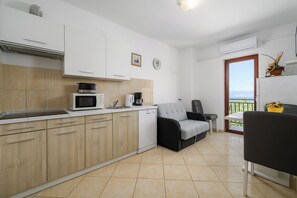 Apartment (A7) | Private kitchen | Fridge, microwave, stovetop, dishwasher