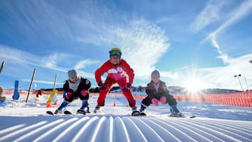 A snowy landscape with a ski slope and a clear sky.