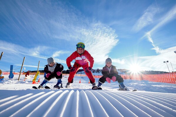 A snowy landscape with a ski slope and a clear sky.