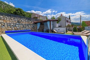 Outdoor pool, a heated pool, pool loungers