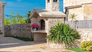 A stone building with a small tower and a stone wall. - Villa Kirstin (Privlaka)