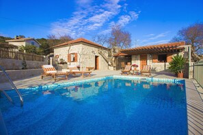 Outdoor pool, a heated pool, open open 24 hours a day, pool umbrellas