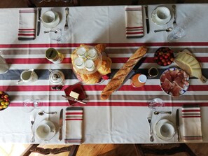 A table set for a meal with various dishes, glasses, and utensils.