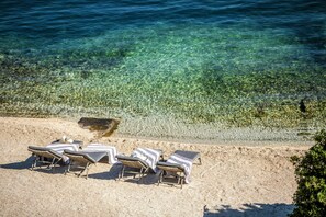 On the beach, sun loungers, beach towels