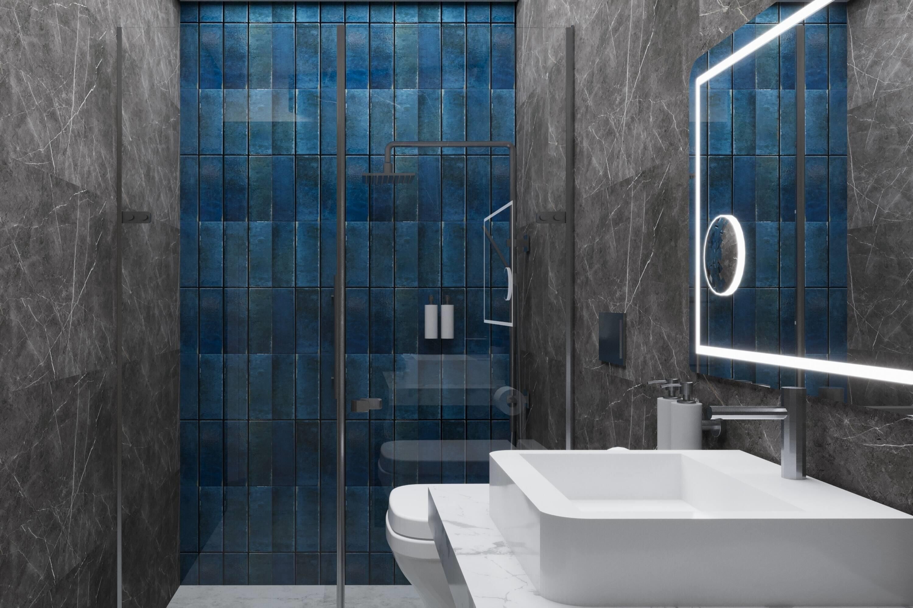 A modern bathroom with a glass shower enclosure, a white sink, and a marble-tiled wall.