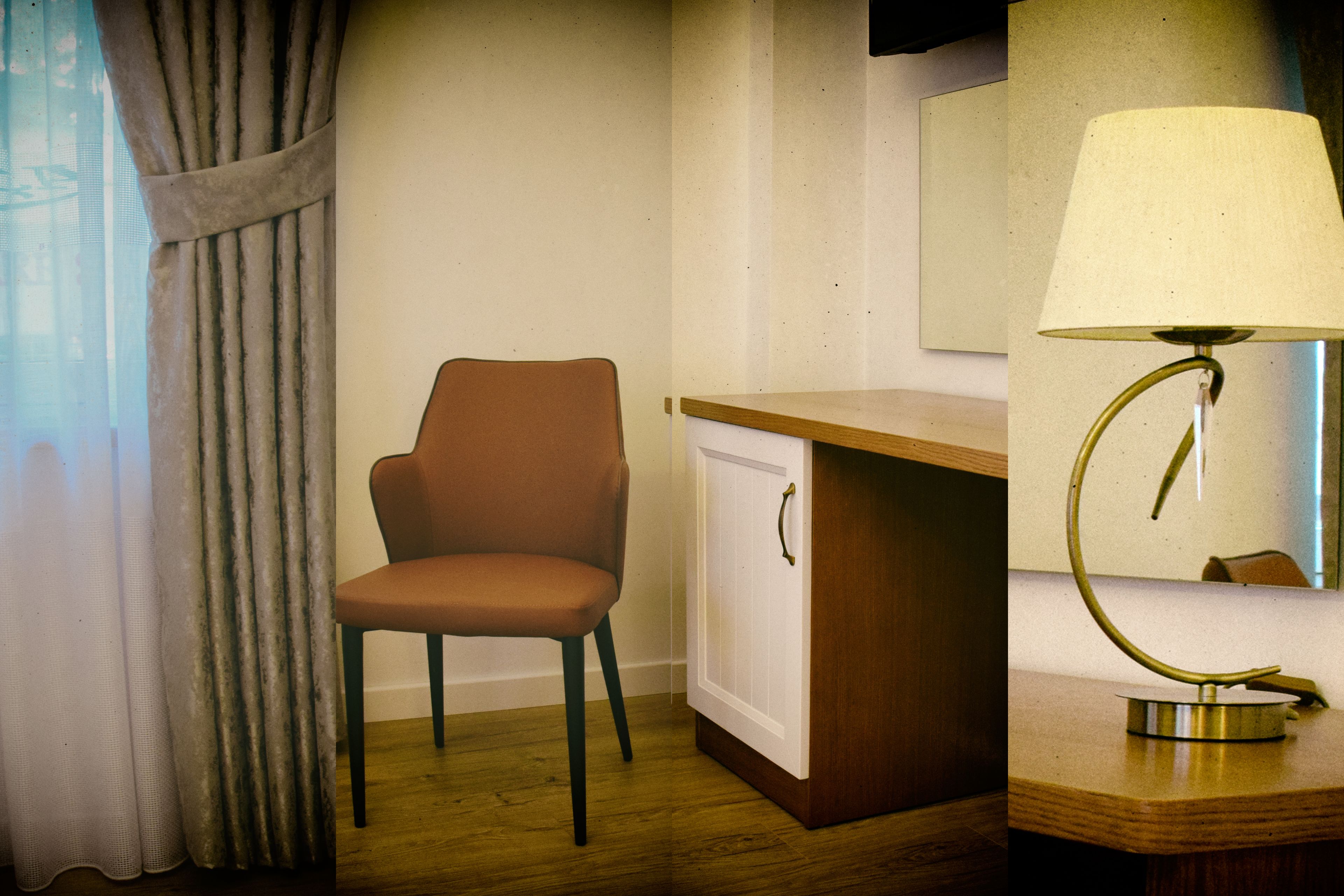 A room with a wooden desk, a chair, a lamp, and a cabinet.