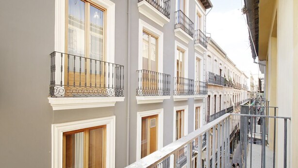 A multi-story building with balconies and windows.