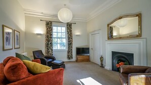 A living room with a fireplace, a television, and a large mirror. - Luxurious Georgian Central Apartment -Parking - 1 (York)