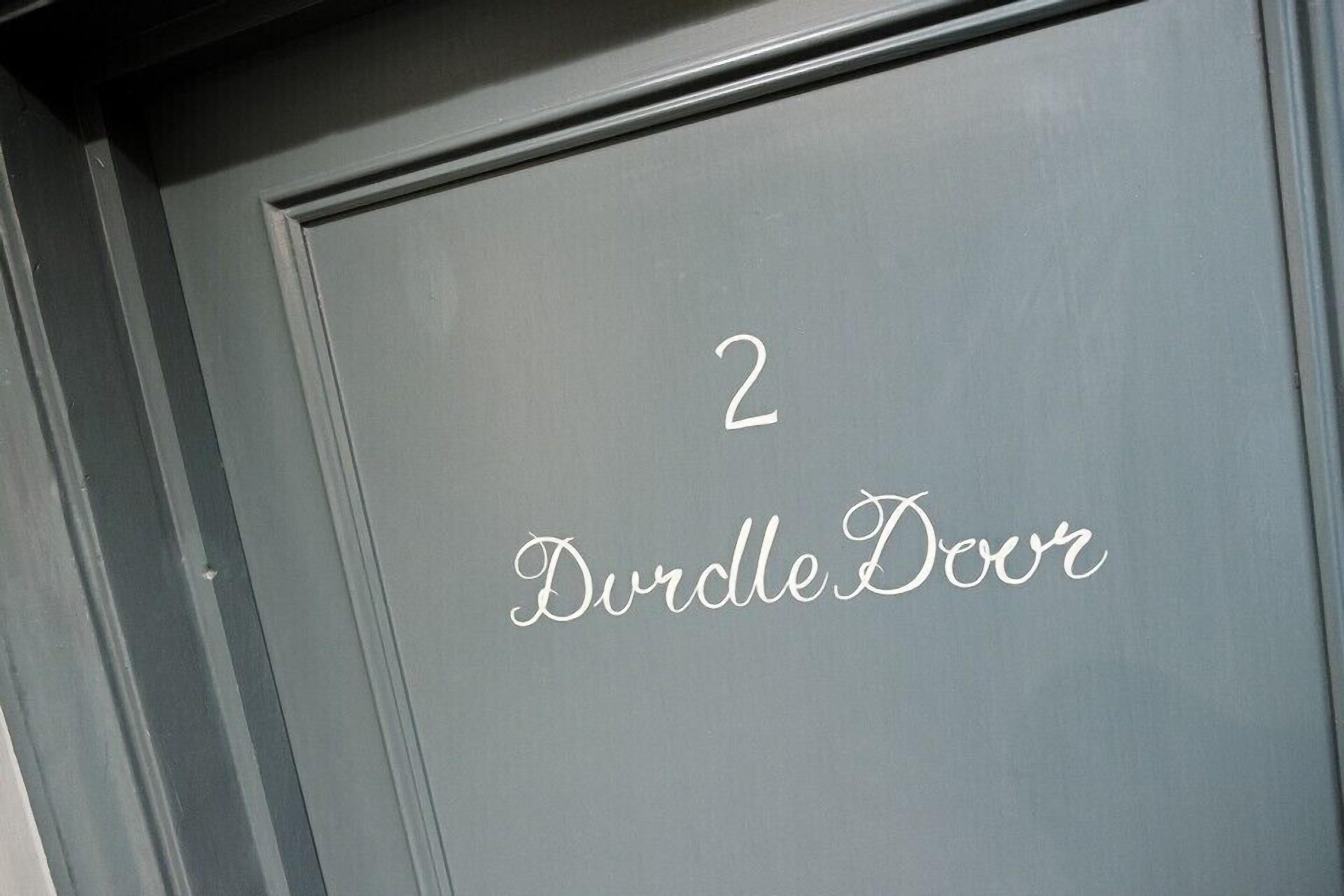 A door with the number "2" and the words "Durdle Door" written on it.