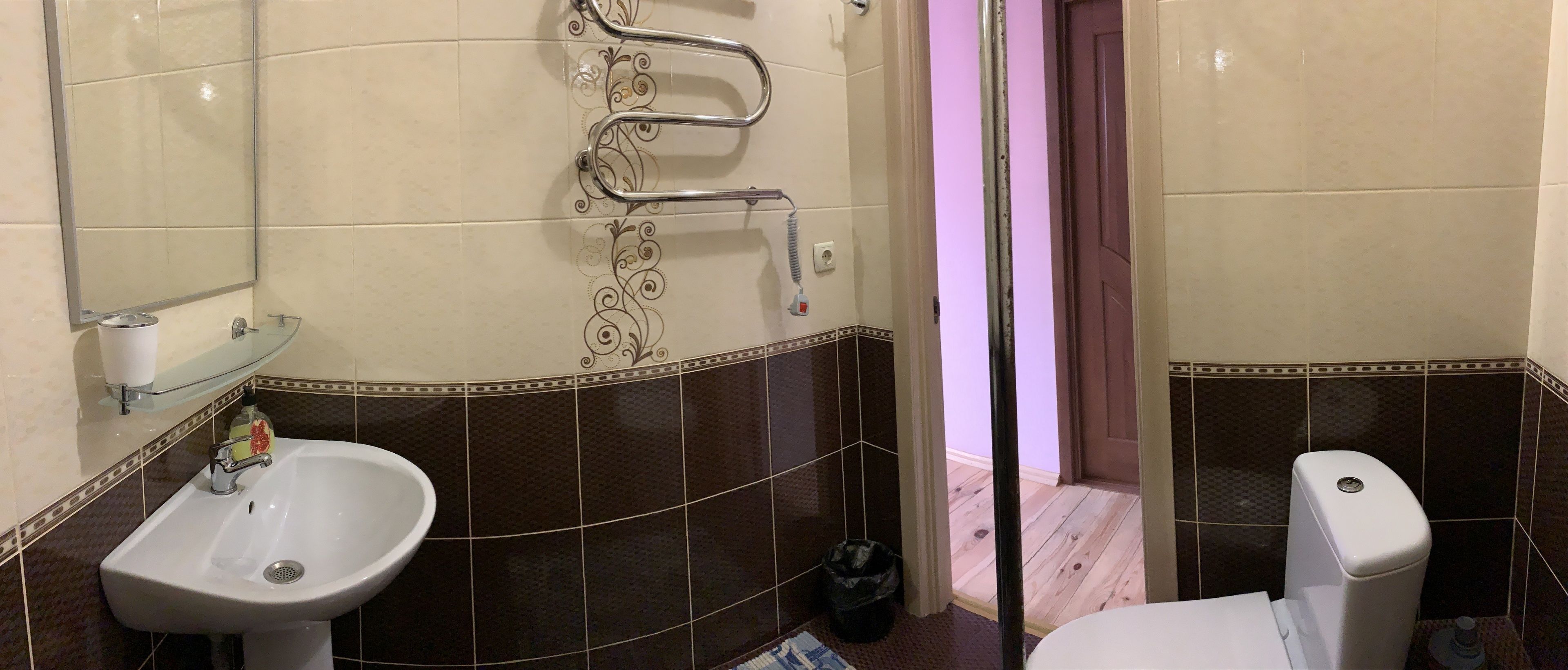 A bathroom with a sink, toilet, and shower area.