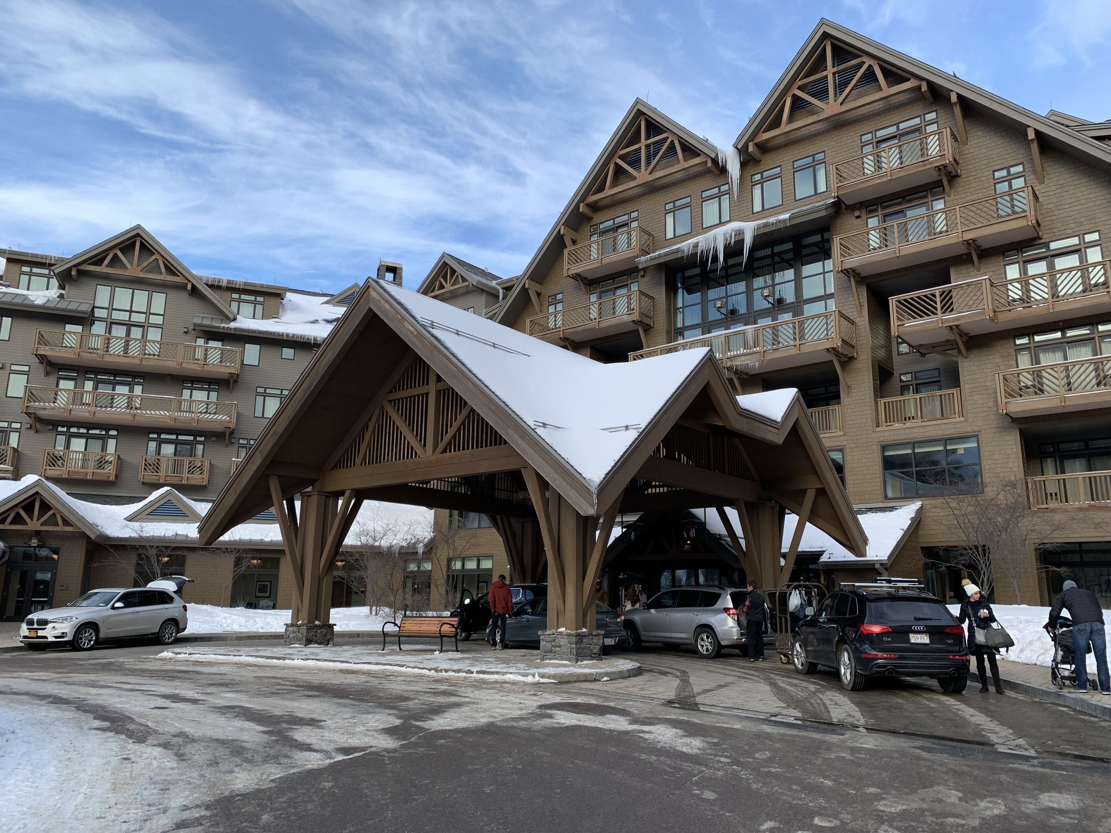A multi-story building with a distinctive wooden facade and a covered entrance.
