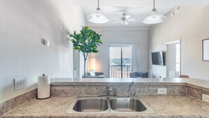 A modern kitchen with granite countertops, double sinks, and a built-in dishwasher. - Mint House Greenville Downtown by Kasa (Greenville)
