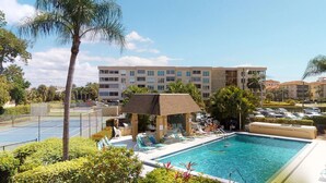 A hotel with a swimming pool, tennis courts, and a covered seating area. - Desirable Location, Directly Across Street From South Beach Access!!! (Marco Island)