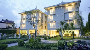A multi-story hotel with a well-maintained garden and outdoor seating area. - Nantra Chiangmai Riverfront Hotel (Chiang Mai)