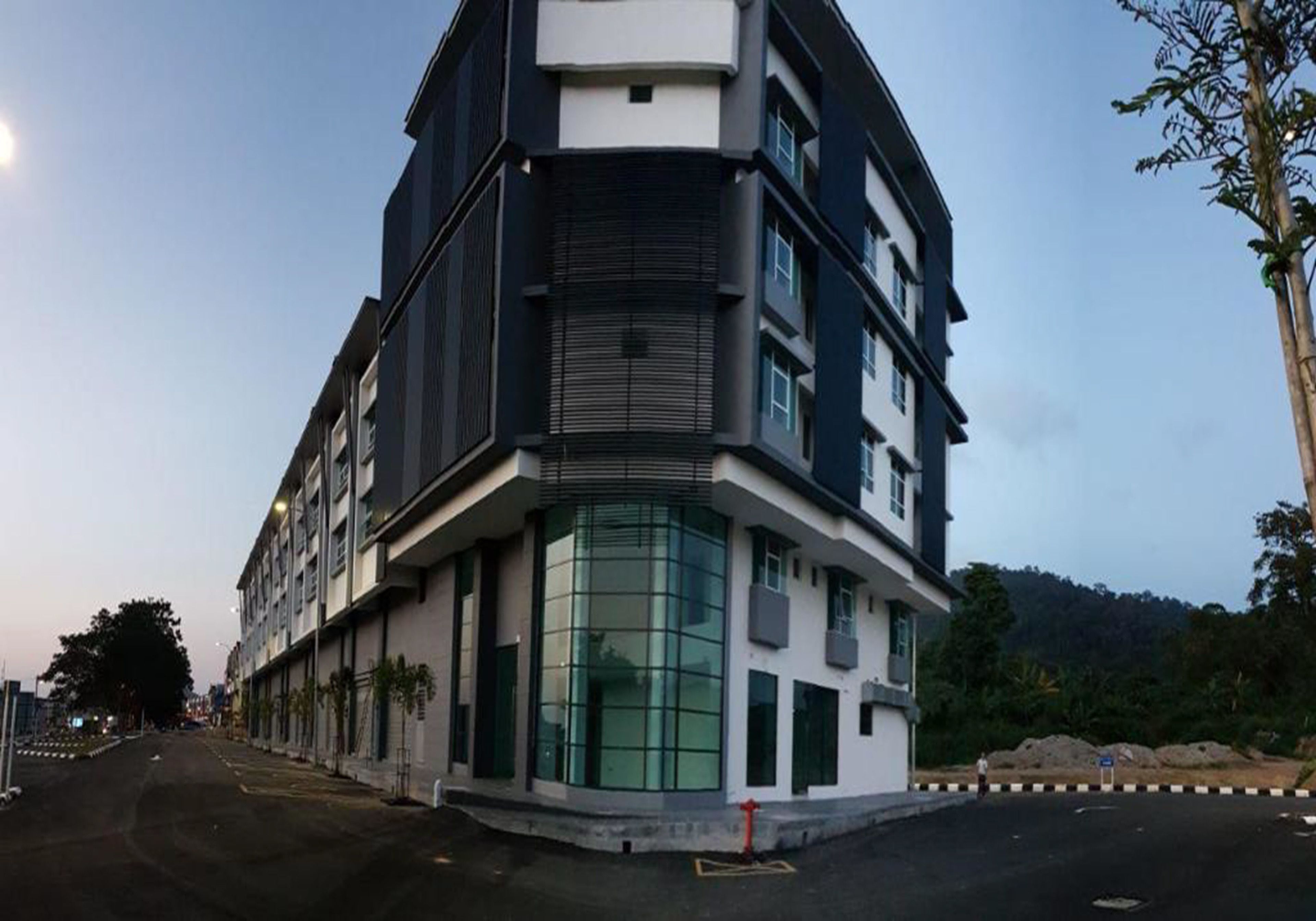 A modern multi-story building with large windows and a flat roof.