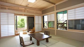 A traditional Japanese room with tatami flooring, a low wooden table, and sliding shoji doors.