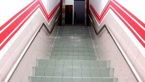 A staircase with green tiles and red and white chevron patterns on the walls. - Super OYO 1173 Mandyrin Hotel (Sibu)