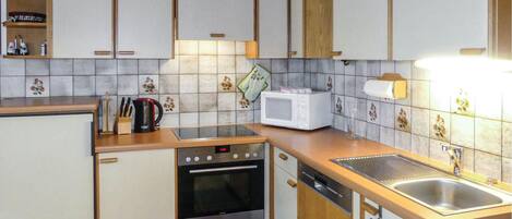 Fridge, stovetop, dishwasher, coffee/tea maker