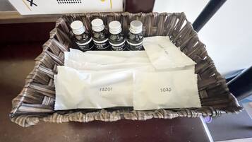 A tray with toiletries including shampoo, razor, and soap.