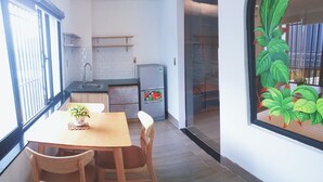 Eine moderne Küche mit Essbereich, Holzmöbeln und einem Kühlschrank.