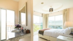 A modern bathroom with a sink, mirror, and window. The room has a balcony with a view. - Baan Anodat (Nonthaburi)