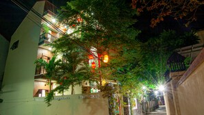 A multi-story building with balconies, a gated entrance, and a pathway leading to the entrance. - Golden Soulmate Homestay (Da Nang)