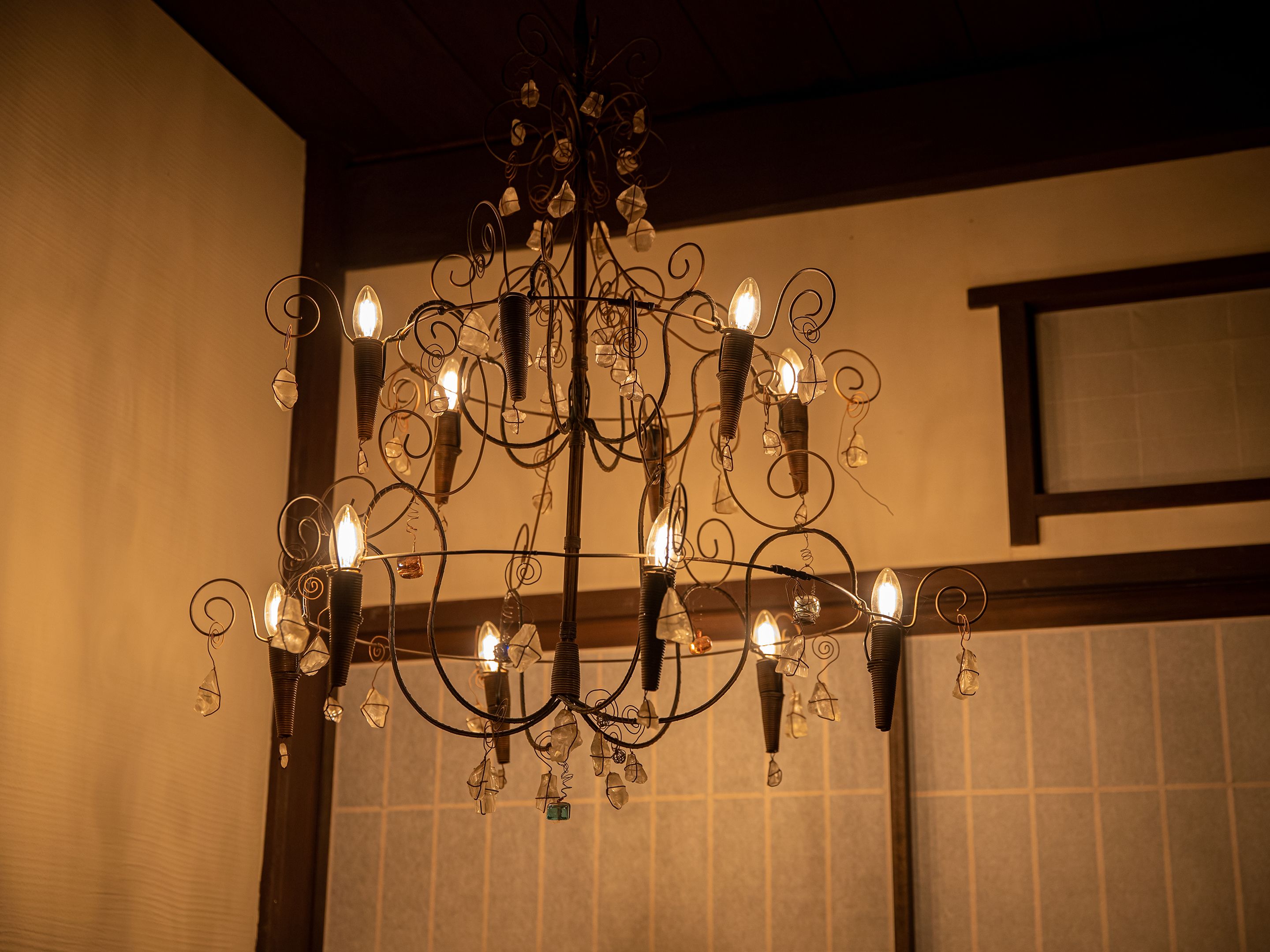 A chandelier with multiple light bulbs and crystal decorations.
